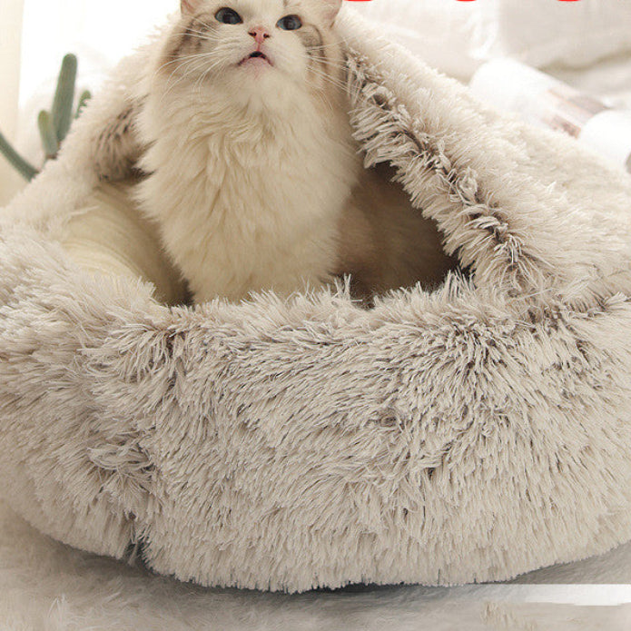 Fluffy pet bed with a cat inside on a light background.