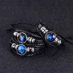 Black braided leather bracelets with blue gemstones on a dark background