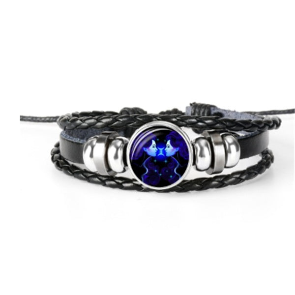 Multistrand bracelet with a blue gemstone on a white background
