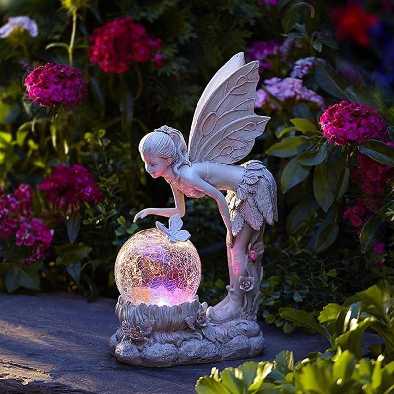 Garden fairy figurine with a glowing crystal ball surrounded by flowers