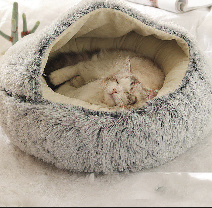 Cat lying in a fluffy gray pet bed