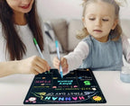 Woman and child drawing on a colorful board with markers.