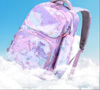 A pastel backpack with a purple, pink, and blue abstract watercolor pattern, floating above white clouds against a bright blue sky background. 