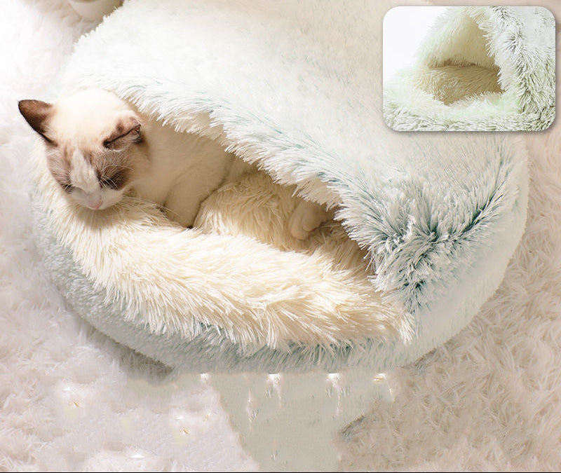 Cat lying in a fluffy white pet bed with a close-up inset showing the texture, on a soft white background.