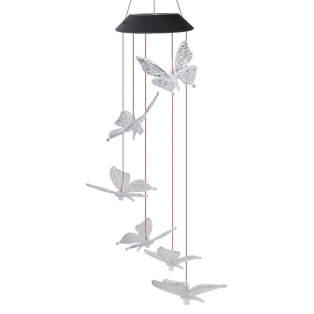 A hanging wind chime featuring multiple white butterfly and dragonfly cutouts suspended from a black circular top with thin metal rods, shown on a plain white background.