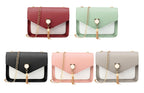 Collection of handbags in various colors with chain details, displayed against a white background.