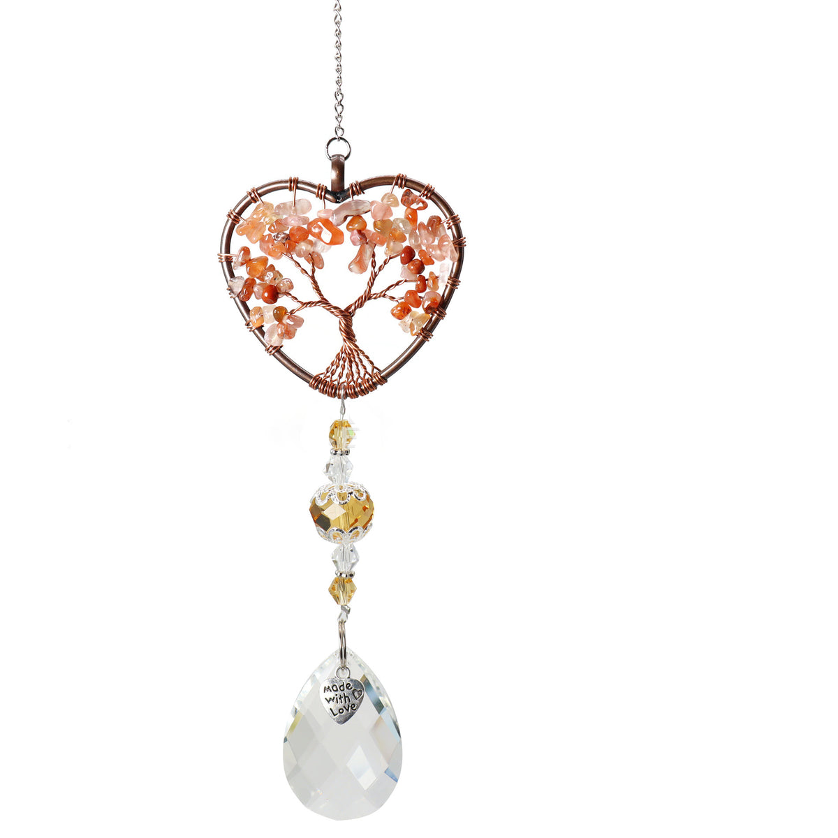 Heart-shaped crystal ornament with tree design on a white background