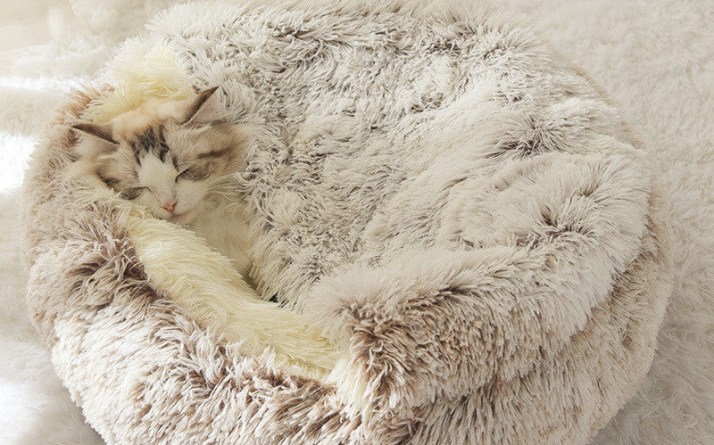 Fluffy pet bed with a cat inside.