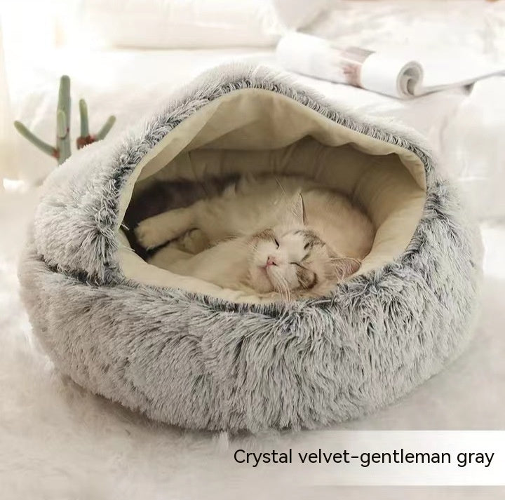 Fluffy gray pet bed with a cat inside on a soft white background