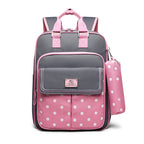 Gray and pink backpack with polka dot design on a white background
