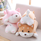 Two plush toys shaped like cartoon animals on a light-colored surface.