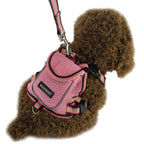 Pink dog harness with a brand logo on a brown dog