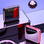 Two electronic devices with digital displays on a reflective surface with a purple gradient background.