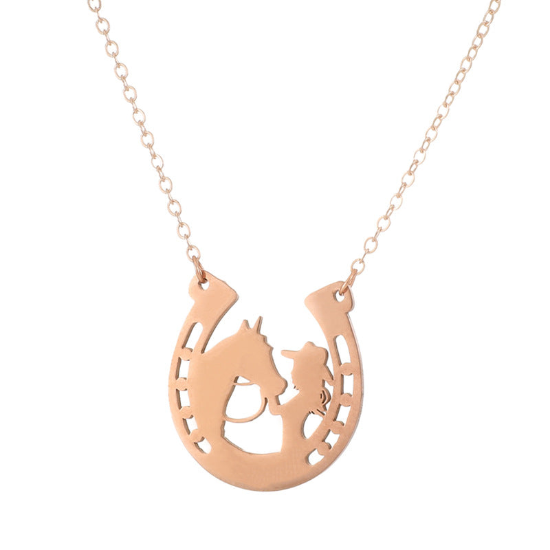 A rose gold necklace featuring a horseshoe-shaped pendant with a silhouette of a cowboy riding a horse, shown against a plain white background.