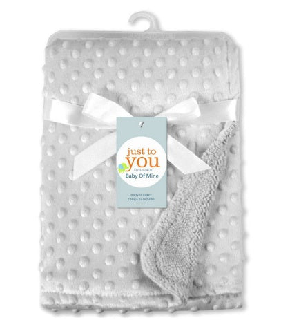 Gray polka dot baby blanket with a white bow and 'just to you' tag on a white background