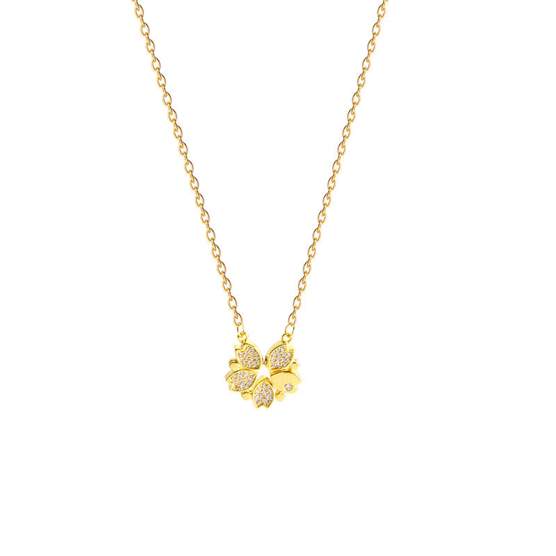 Gold necklace with a butterfly pendant on a white background