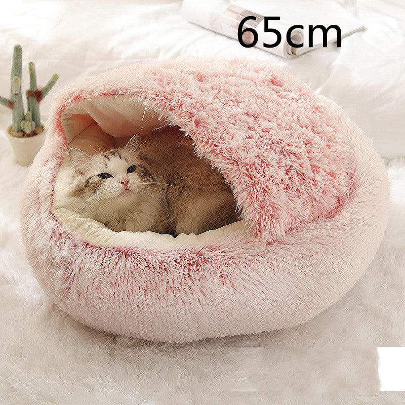 Cat lying in a pink plush pet bed with a size label '65cm' on a white background.