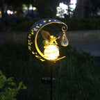 Decorative garden light with fairy on a moon design, glowing in the dark.