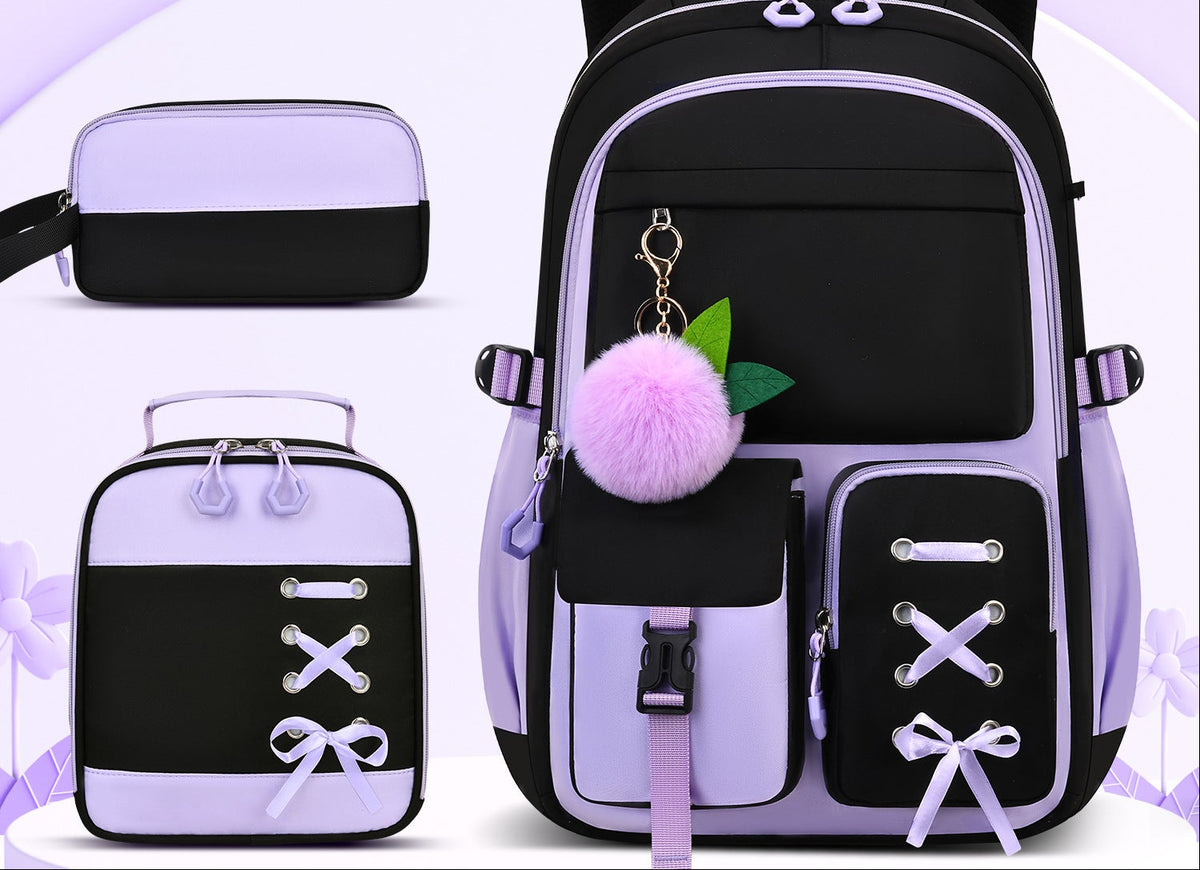 A black and lavender school backpack set shown on a light purple background, including a large backpack, a small matching pouch, a lunch bag, and a pen case. 