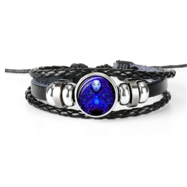 Black braided leather bracelet with a blue and silver circular charm on a white background