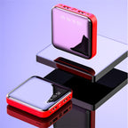 Red and black electronic device with digital display on a reflective surface