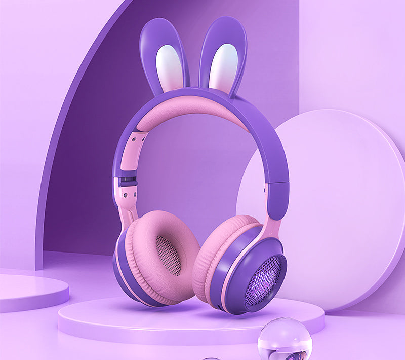 Pink and purple headphones with bunny ears on a purple background