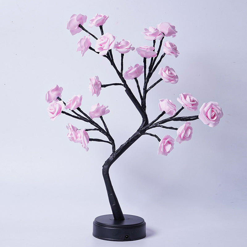 Decorative LED tree with pink flowers on a white background