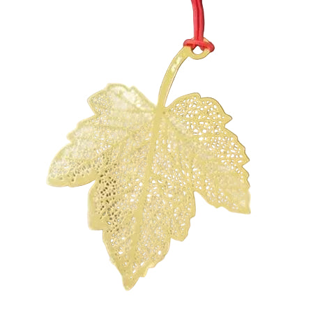 Gold leaf-shaped pendant on a red string, on a white background 