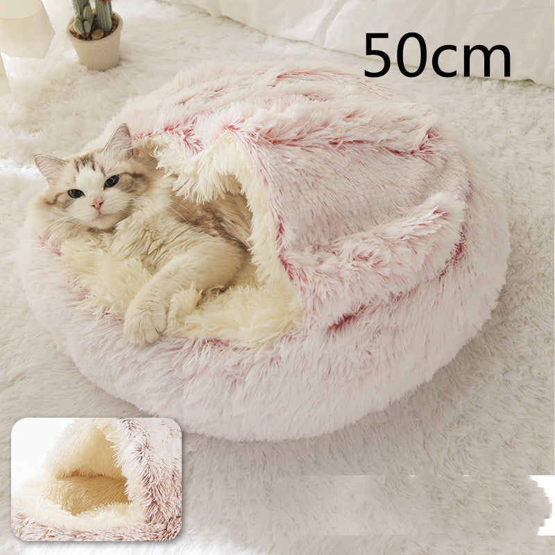 Cat lying in a fluffy pink pet bed with a measurement label on a soft surface.