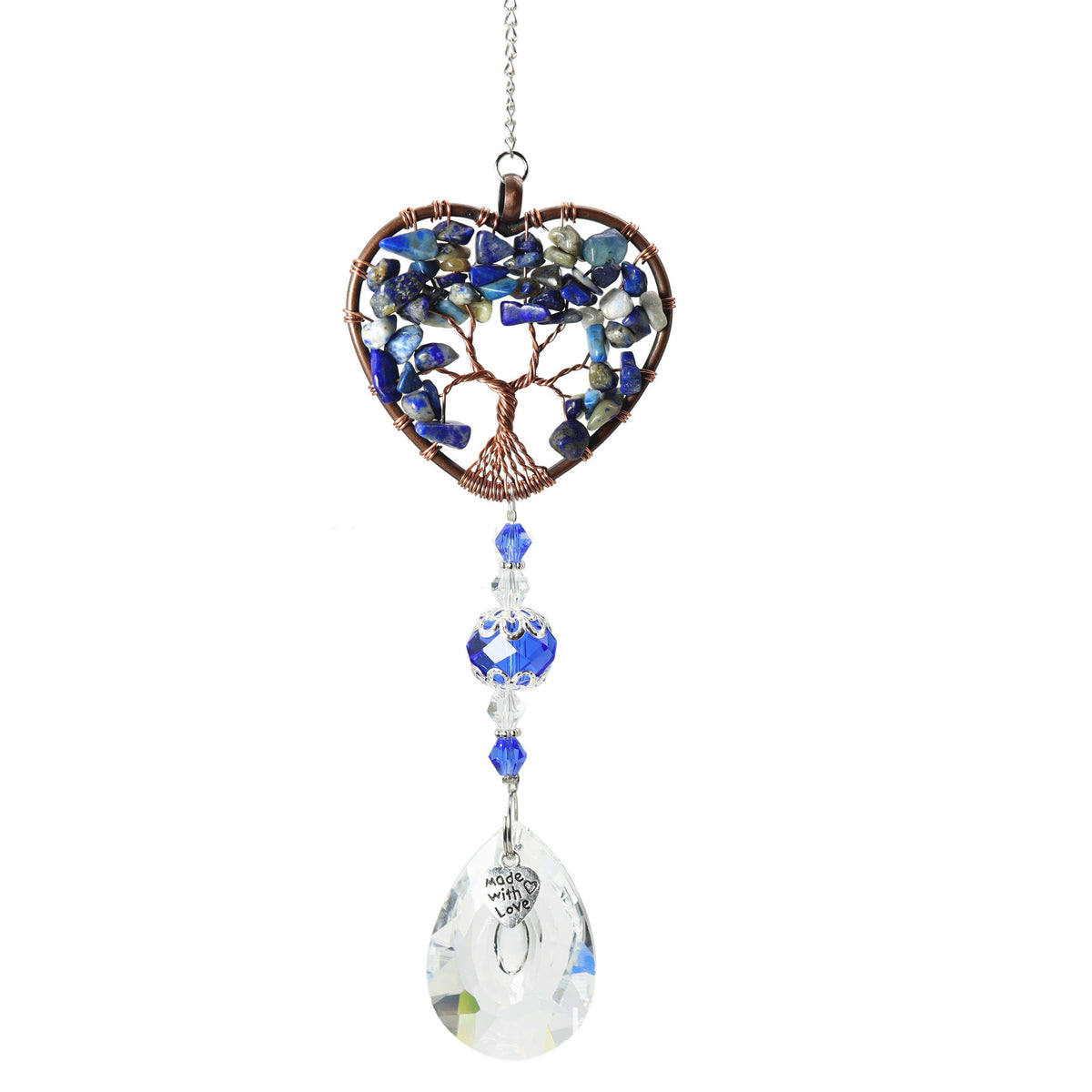 A heart-shaped suncatcher with a tree of life design made from blue and gray stone chips in a copper wire frame, hanging from a silver chain with blue and clear beads and a faceted clear teardrop crystal at the bottom.