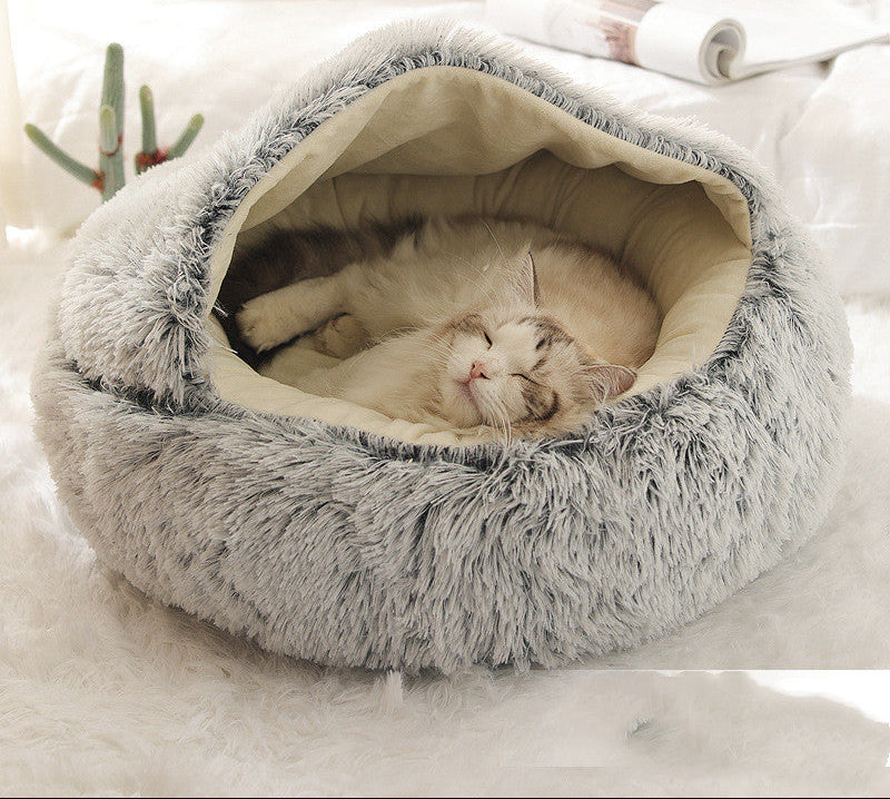 Cat lying in a fluffy gray pet bed 