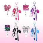 Six different nurse-themed keychains with retractable ballpoint pens, scissors, and accessories, arranged in two rows on a white to pink gradient background. The keychains feature various designs including a pink bow, a progress sign, a coffee scrubs sign, and a glittery bow.