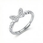 A silver adjustable ring featuring a butterfly motif adorned with small clear stones, set against a clean white background.