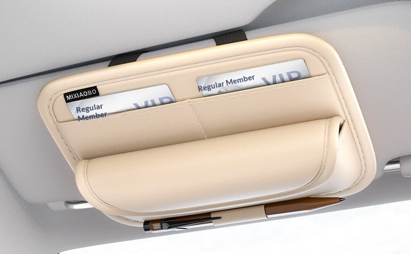 Car visor with a beige eyeglass case holding two pairs of glasses, with promotional text about a second-generation product.