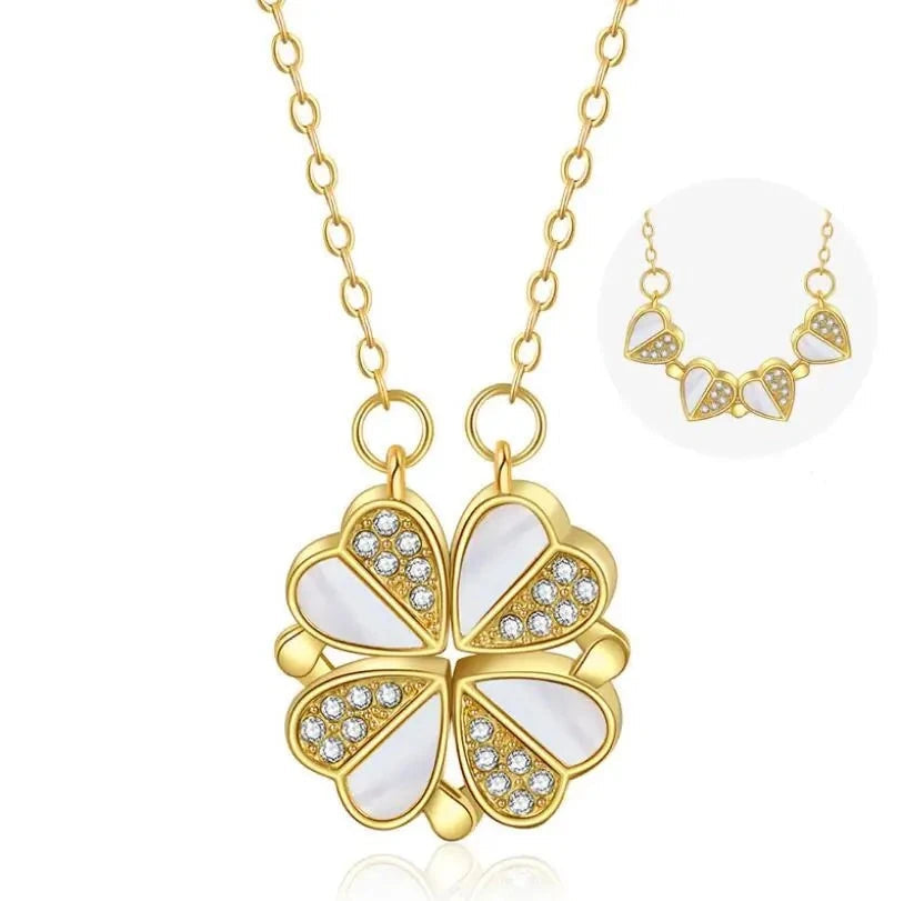 Gold necklace with a four-leaf clover pendant on a white background