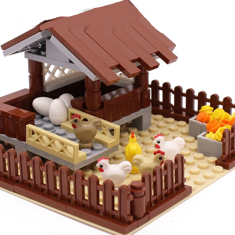 Toy farm set with chickens and a coop made of interlocking bricks.