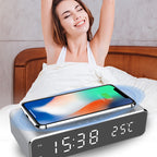 Woman waking up with a smartphone on a digital alarm clock in bed