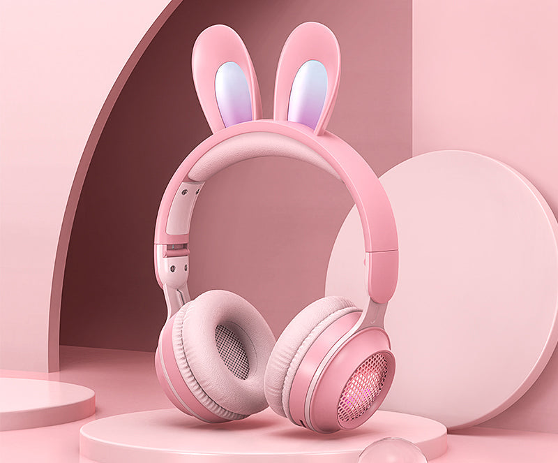 Pink headphones with bunny ears on a pink background