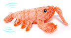 Cat playing with a plush lobster toy on a white background